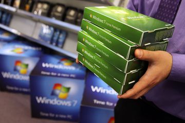 Homme transportant des boîtes de vente au détail de Windows 7